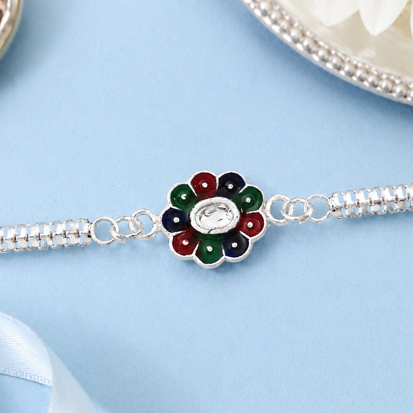 Handcrafted colorful petal Rakhi displayed on silver chain