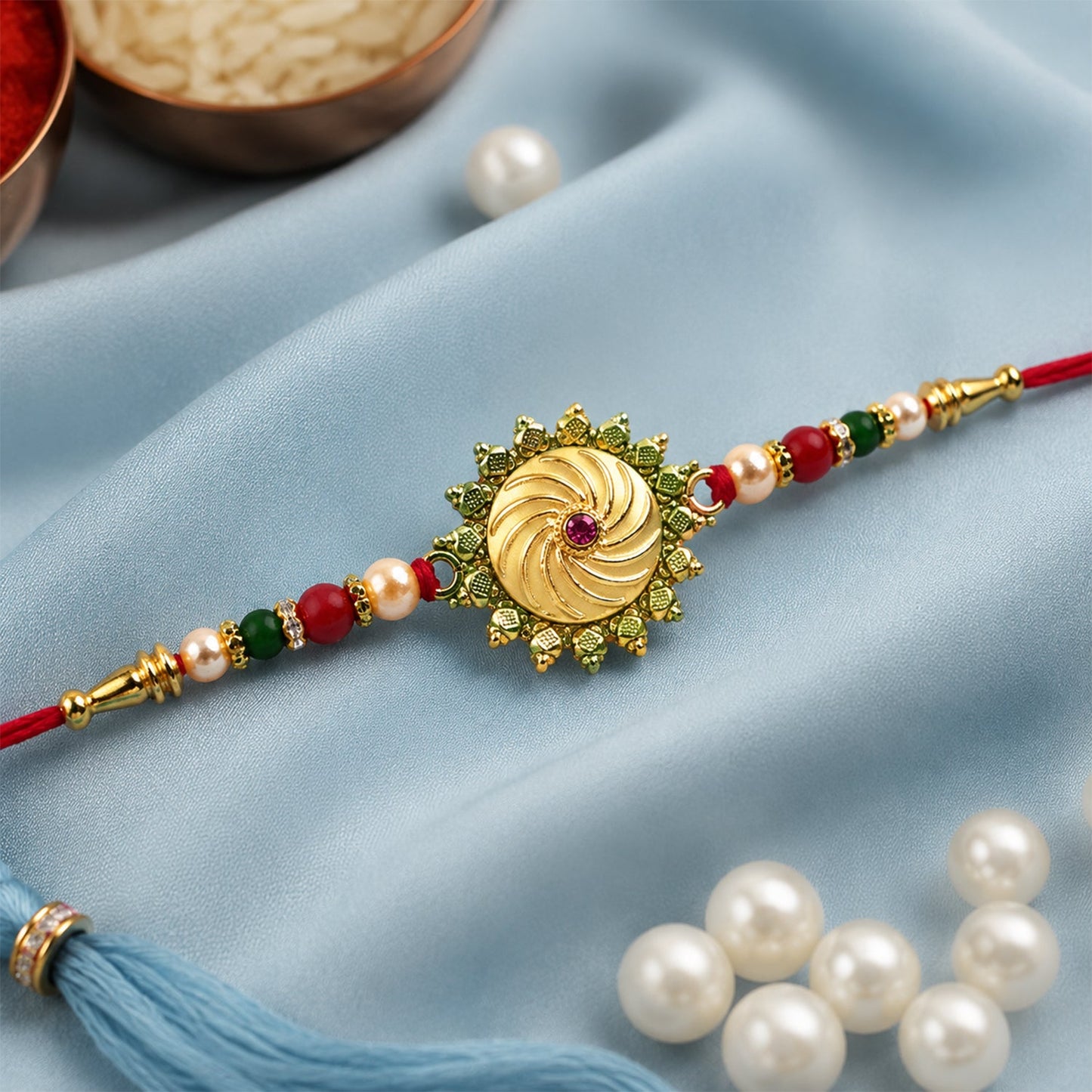 Round shape rakhi decorated with detailed stone and bead work on red thread