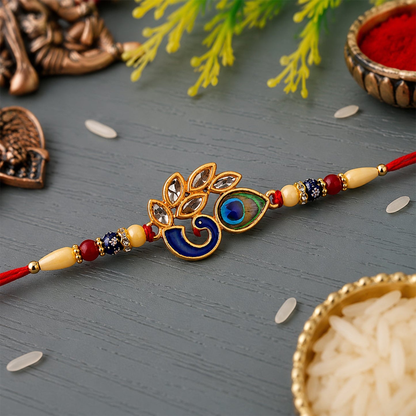 Mor Pankh Rakhi with colorful enamel and traditional red thread, front view