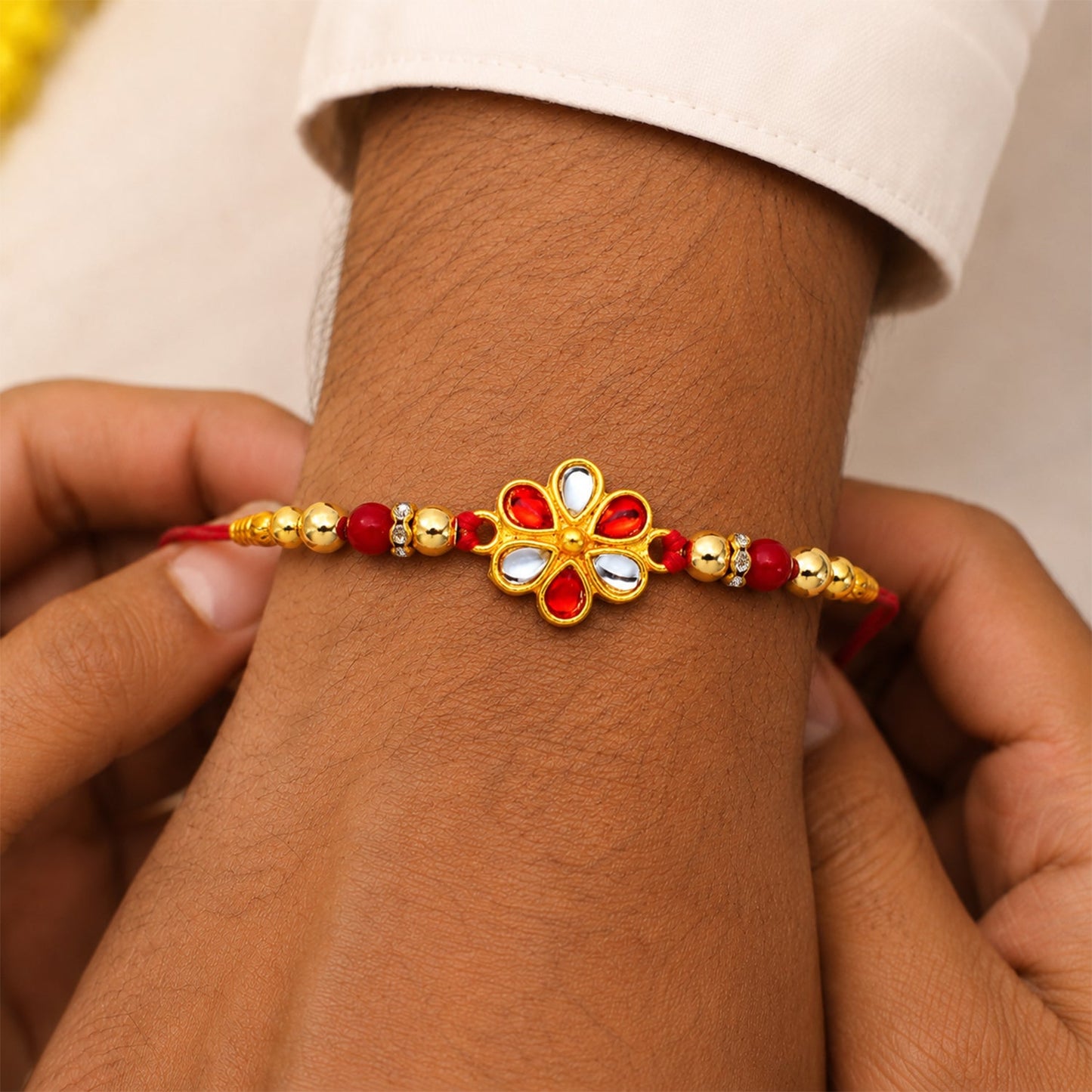 Red White Beaded Rakhi with Kundan Floral Centerpiece – Elegant Design