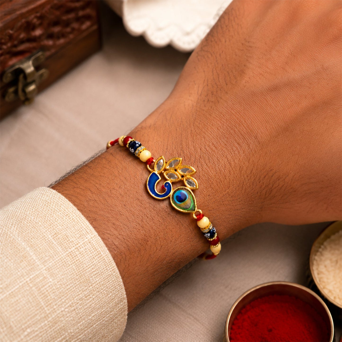 Close-up of Mor Pankh Rakhi highlighting colorful enamel details and peacock feather design