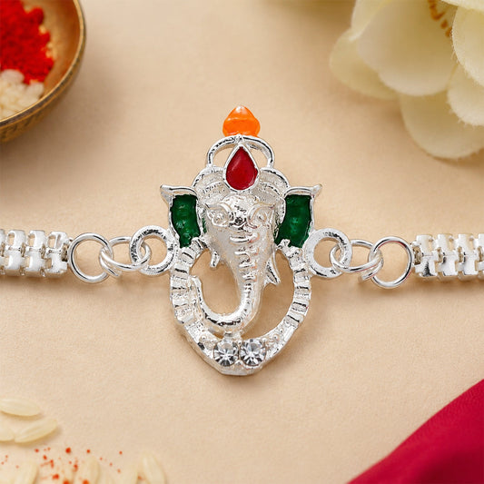 Elegant Ganesha Rakhi with vibrant enamel highlights on a silver metal chain, ready for Raksha Bandhan.