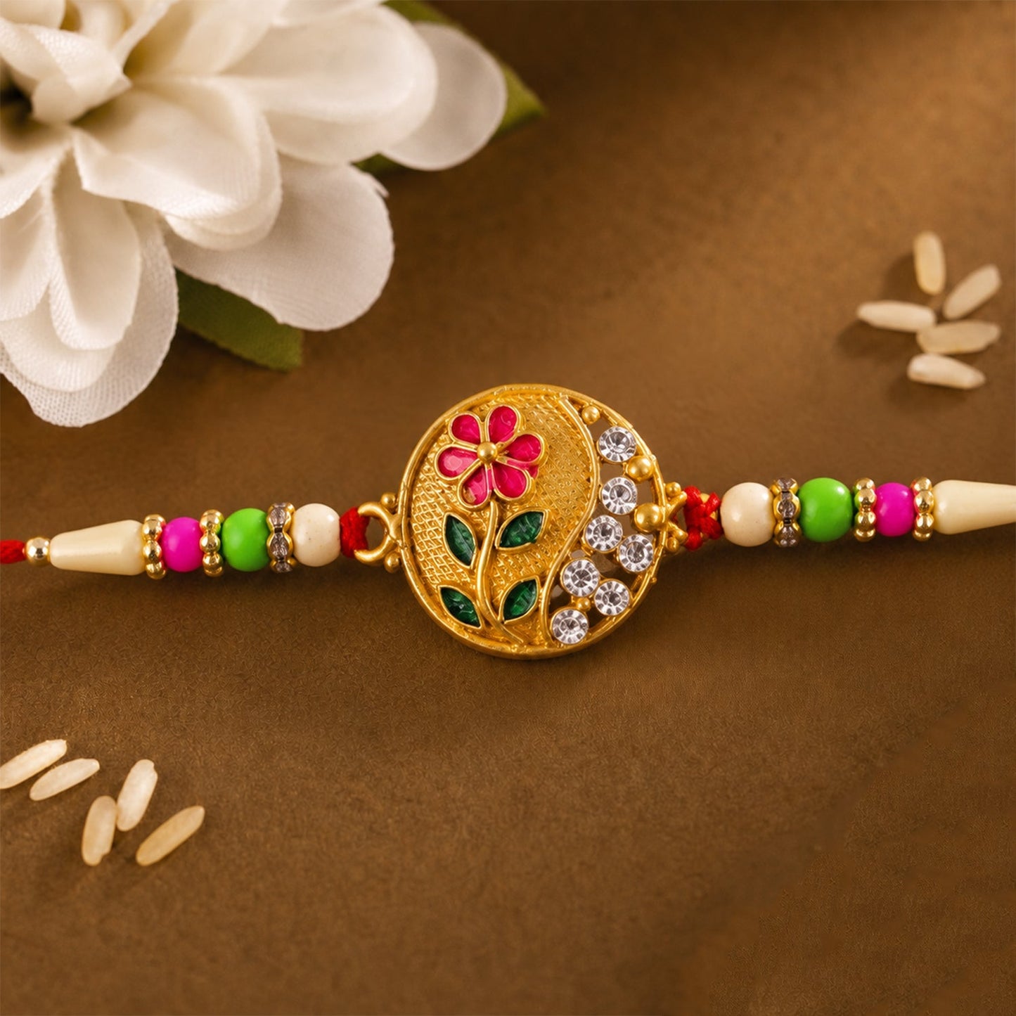 Traditional flower design Rakhi with red-green beads highlighting festive charm