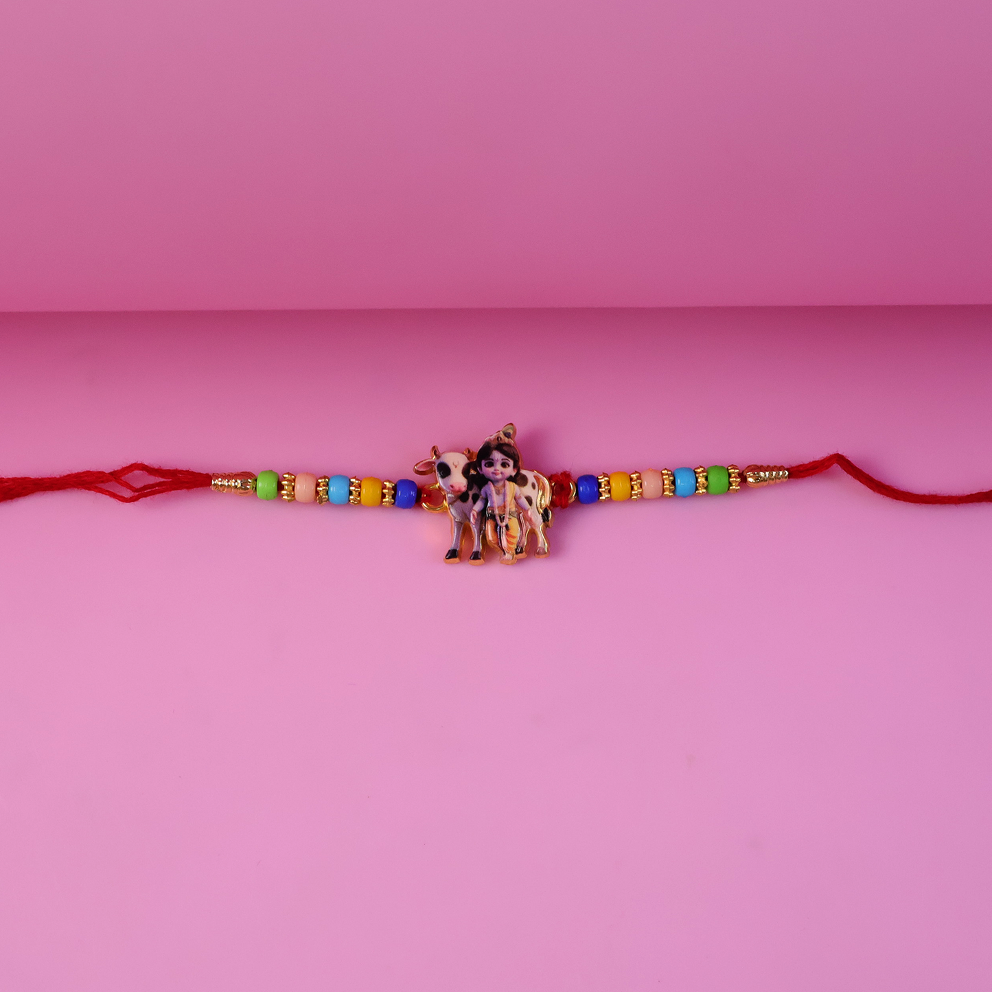 Fine craftsmanship detailed Lord Krishna figure on the Rakhi.