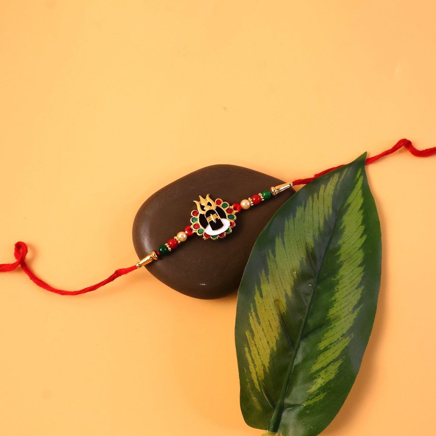 Multiple views of Shiva Rakhi with beadwork