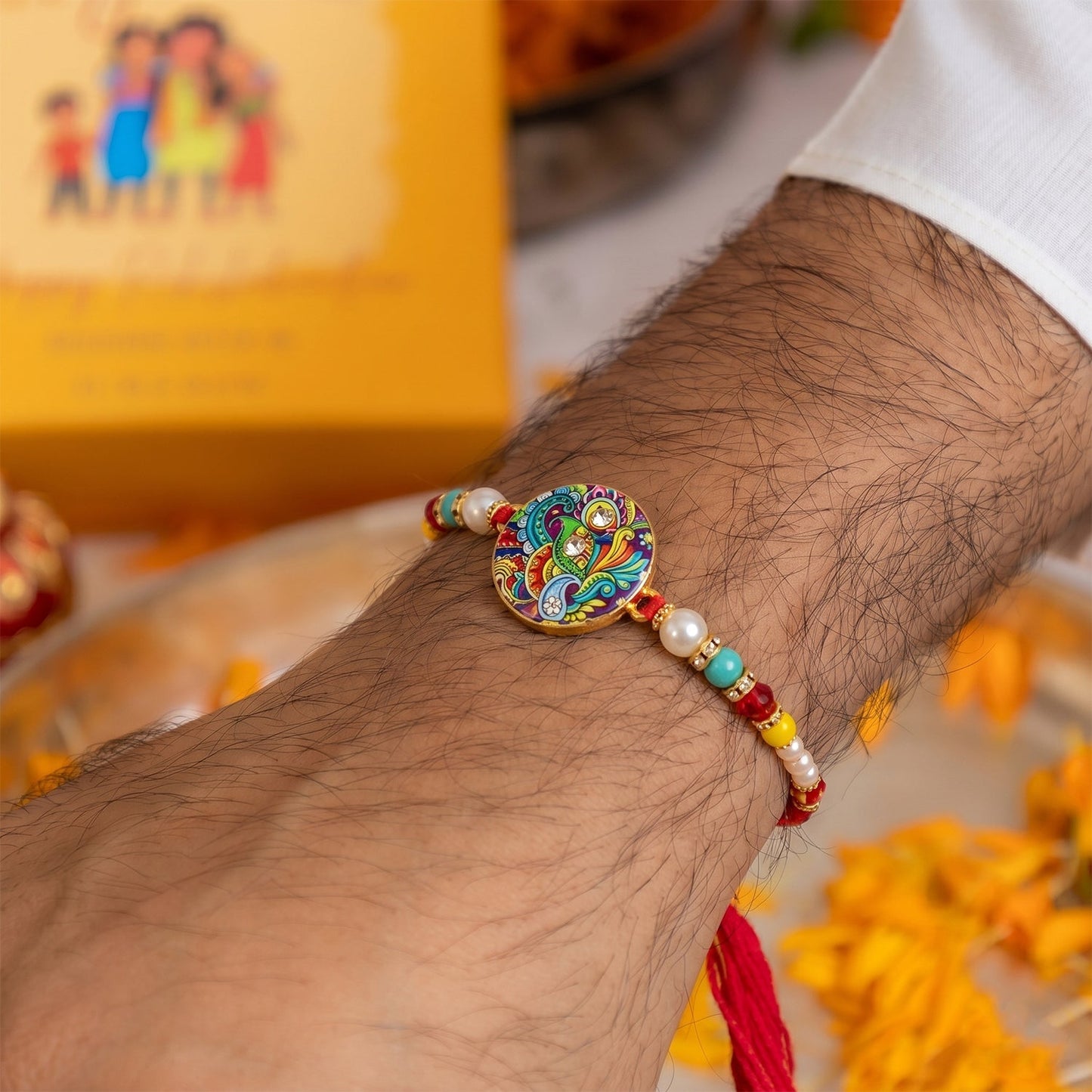 Side view of durable Rakhi with soft thread and pearl embellishments