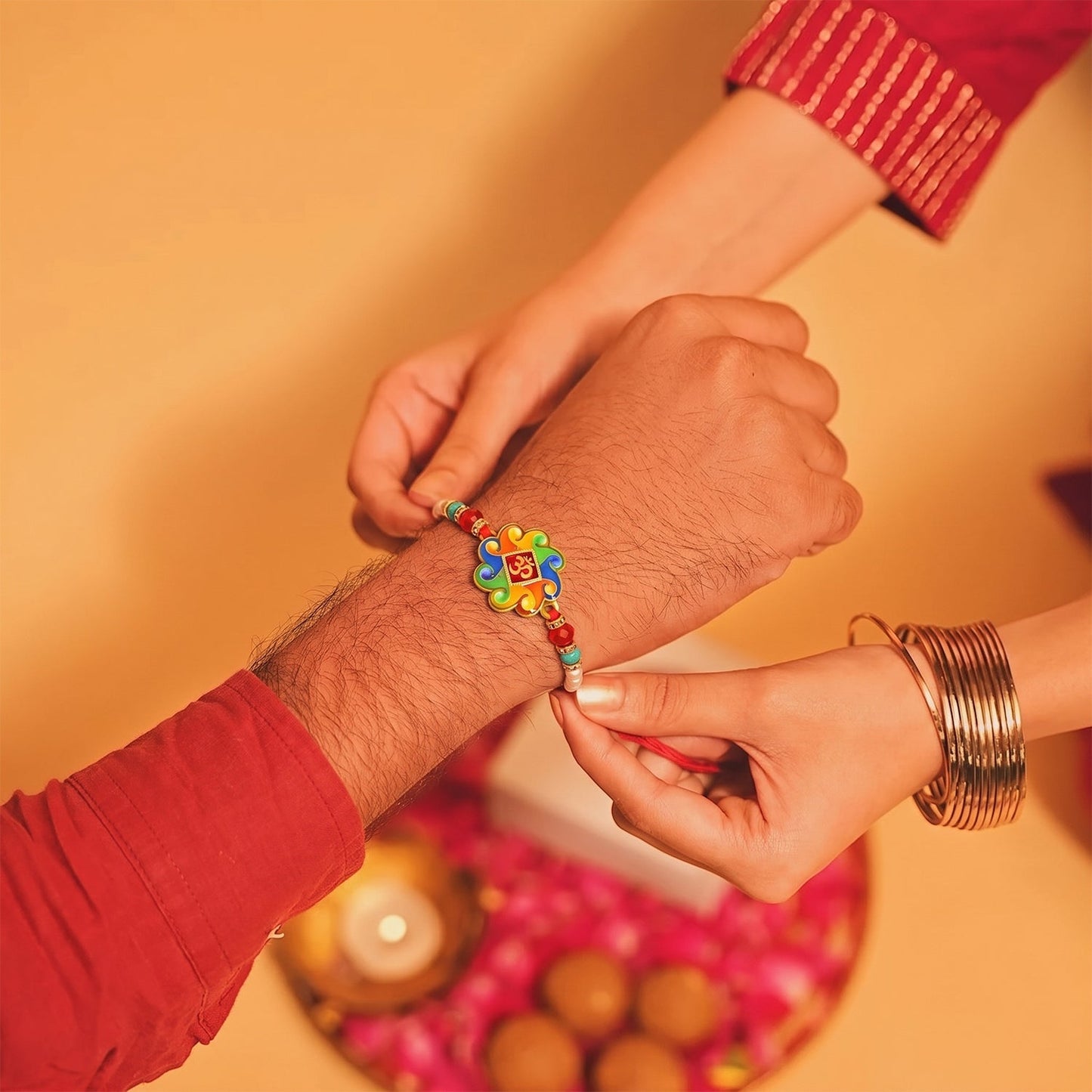 Stylish centerpiece of the Om Symbol Rakhi, highlighting intricate design and beadwork