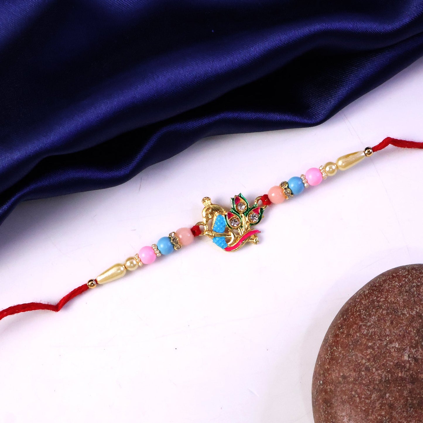 Festive Rakhi featuring peacock design with colorful beads
