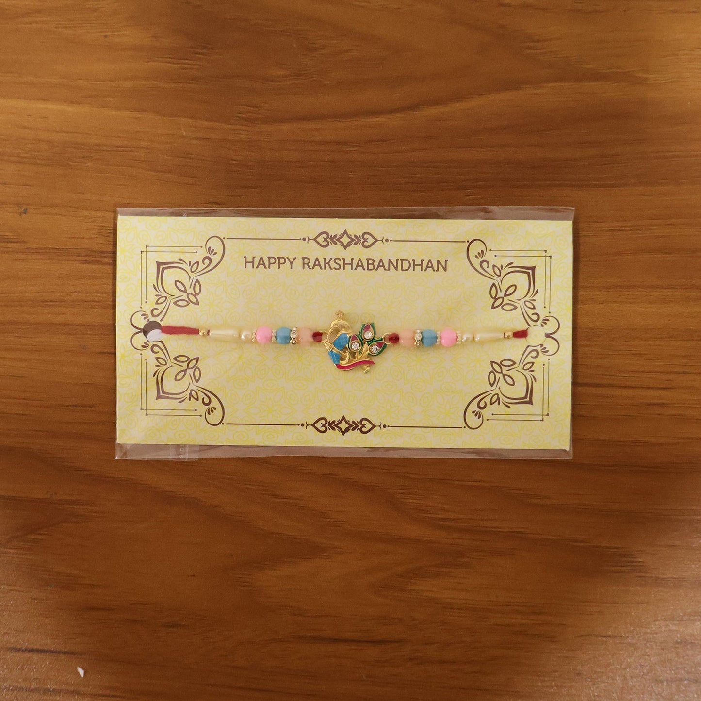 Premium peacock motif Rakhi displayed with decorative background