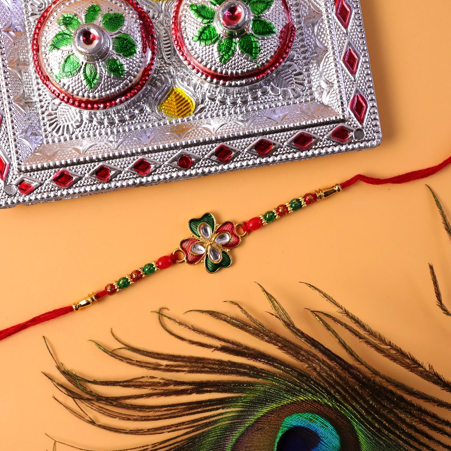 Side view of floral designer rakhi showing bead details and thread
