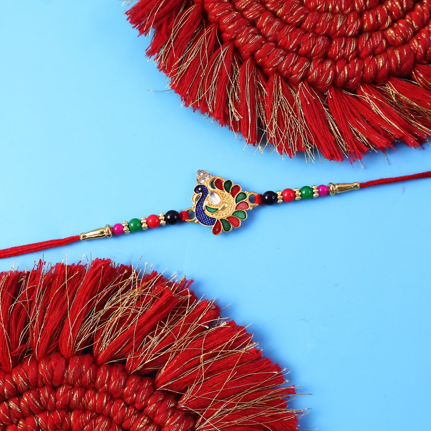 Traditional thread rakhi with detailed peacock design