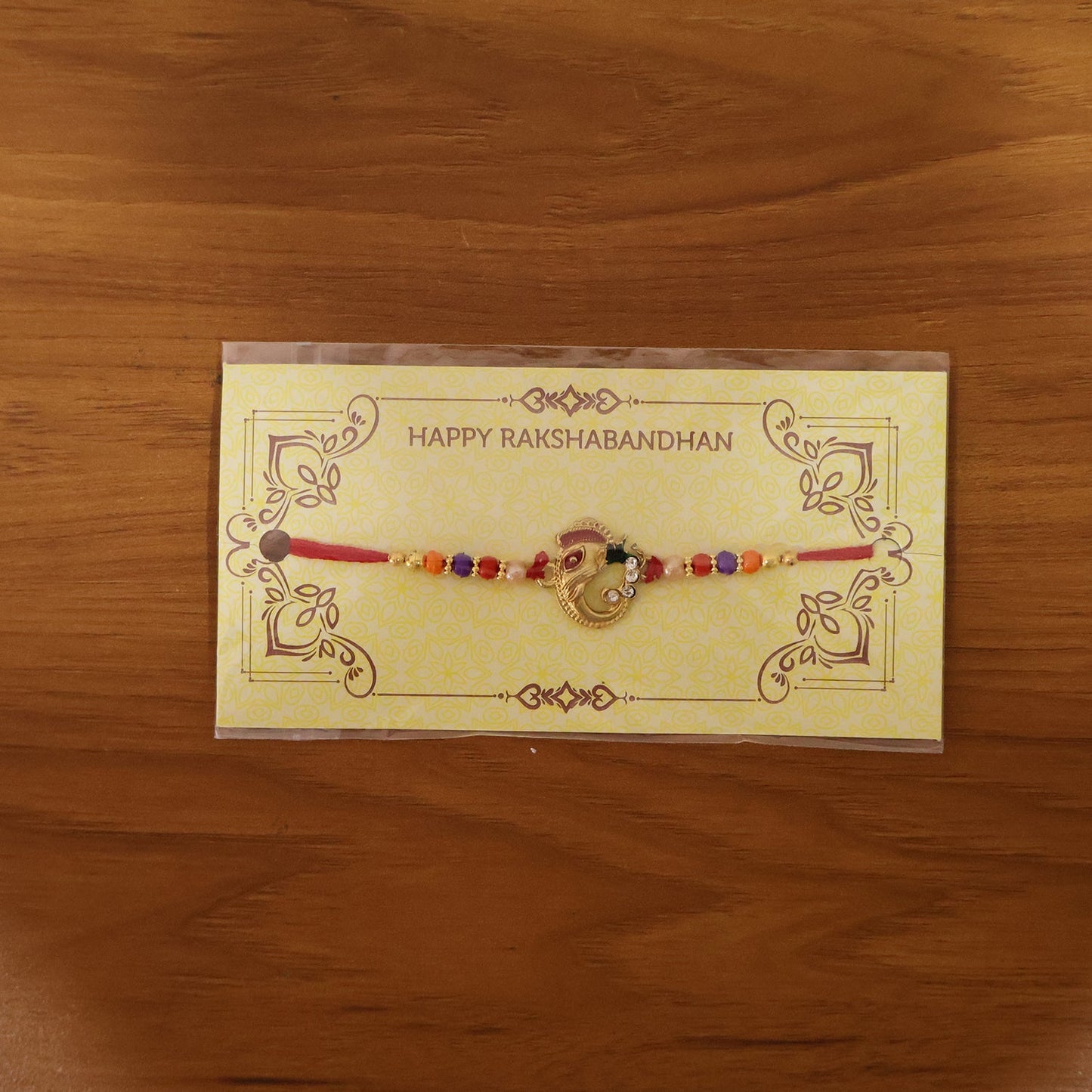 Festive rakhi displayed on hand with intricate threadwork
