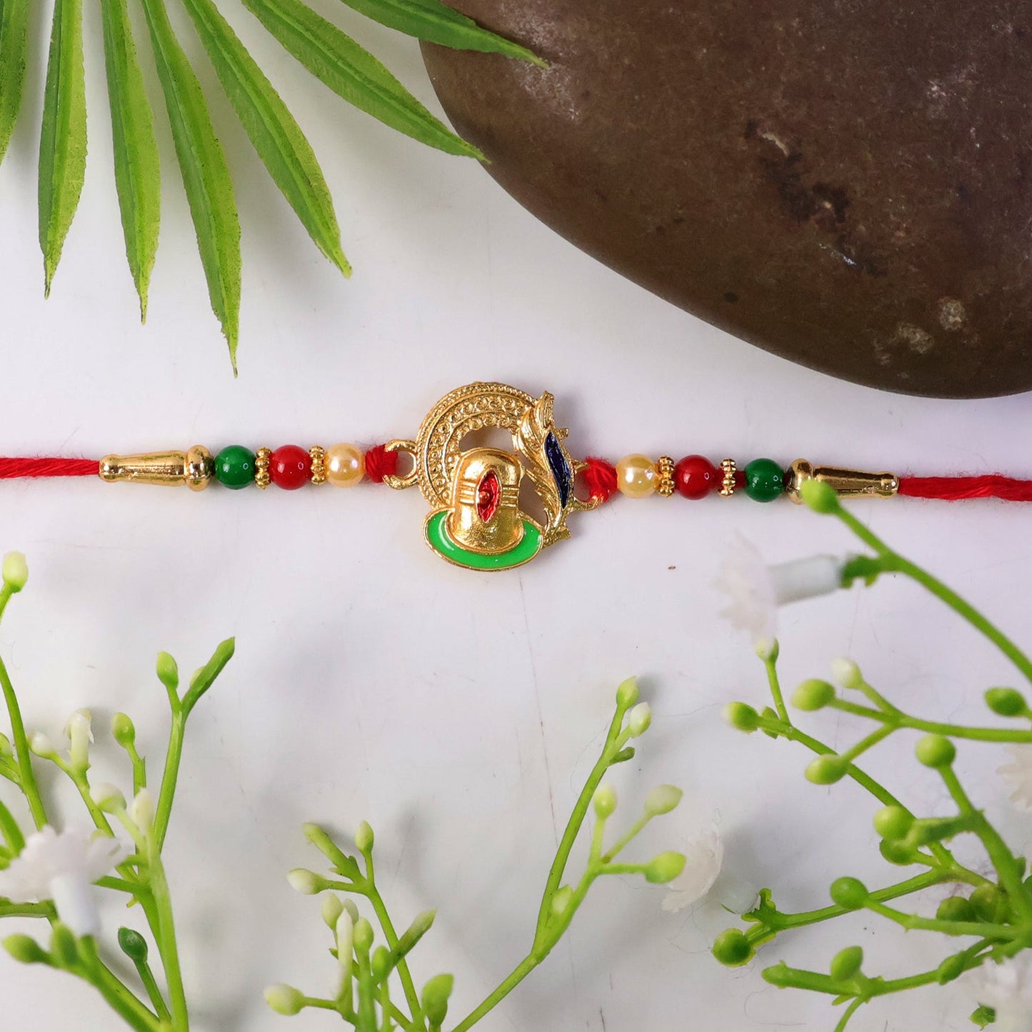 Detailed beads and thread on traditional Ganesha Rakhi