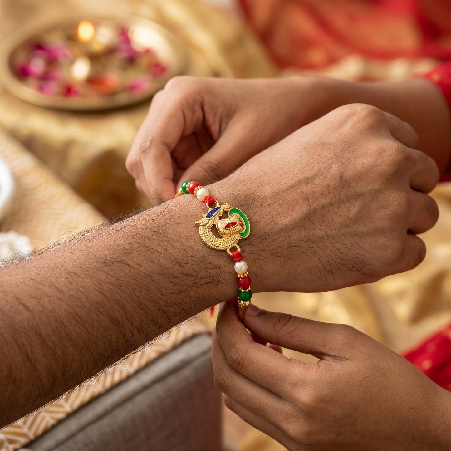 Ganesha Rakhi tied on wrist displaying detailed design