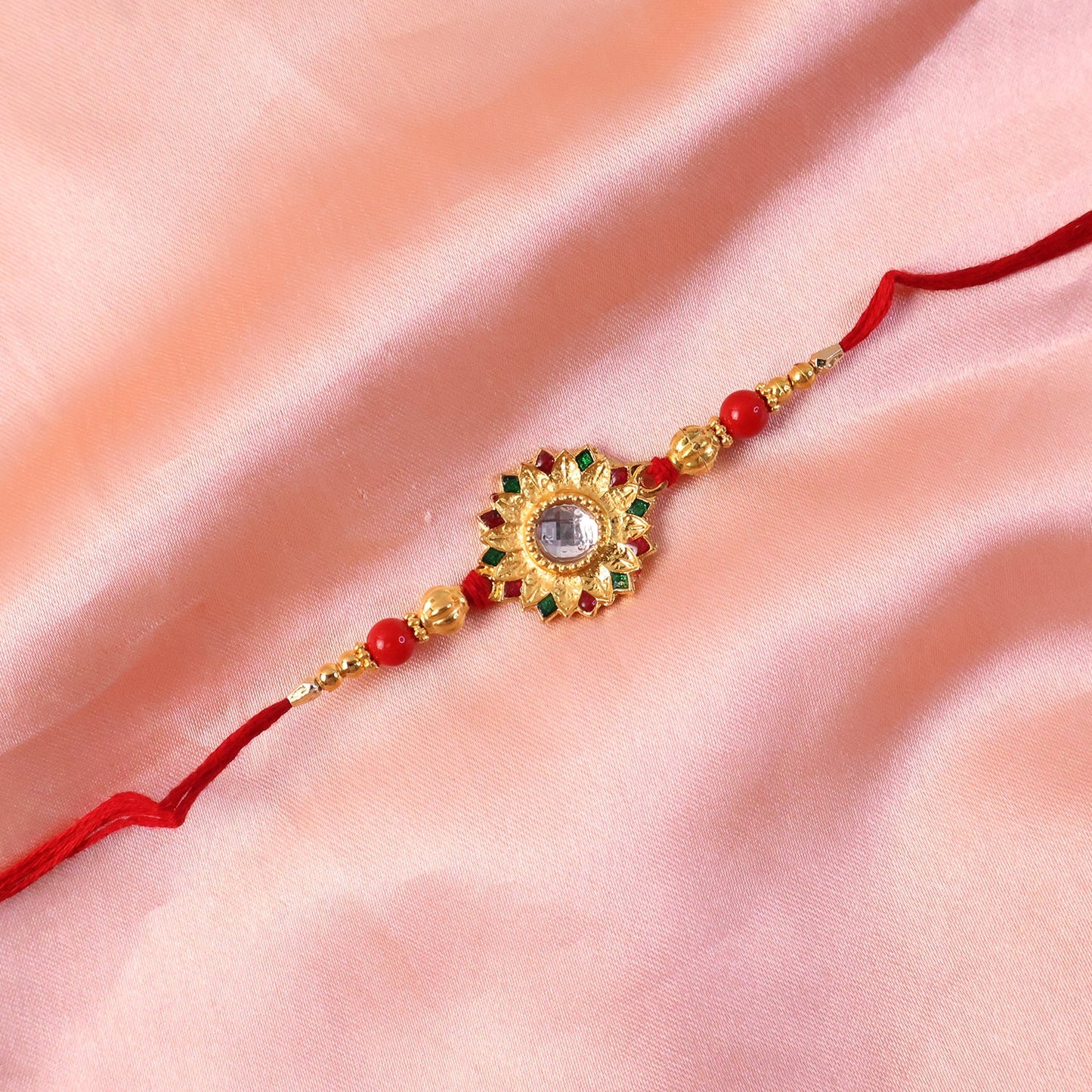 Hand holding Rakhi with detailed craftsmanship, ideal for gifting