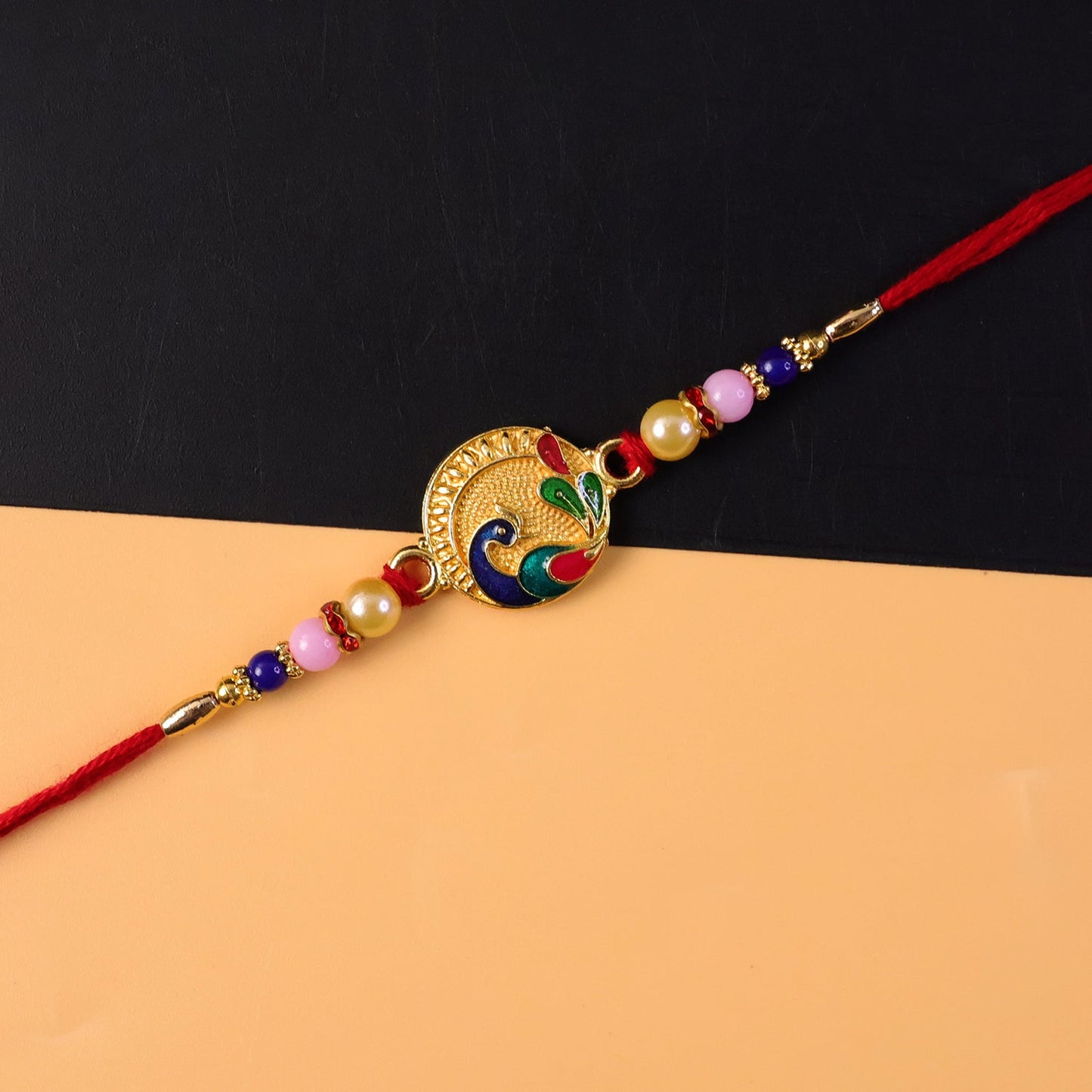 Festive peacock rakhi with decorative elements