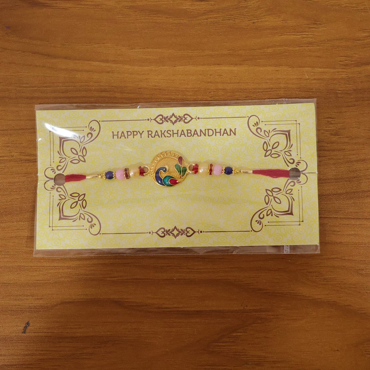 Beautiful peacock motif rakhi with multicolor beads