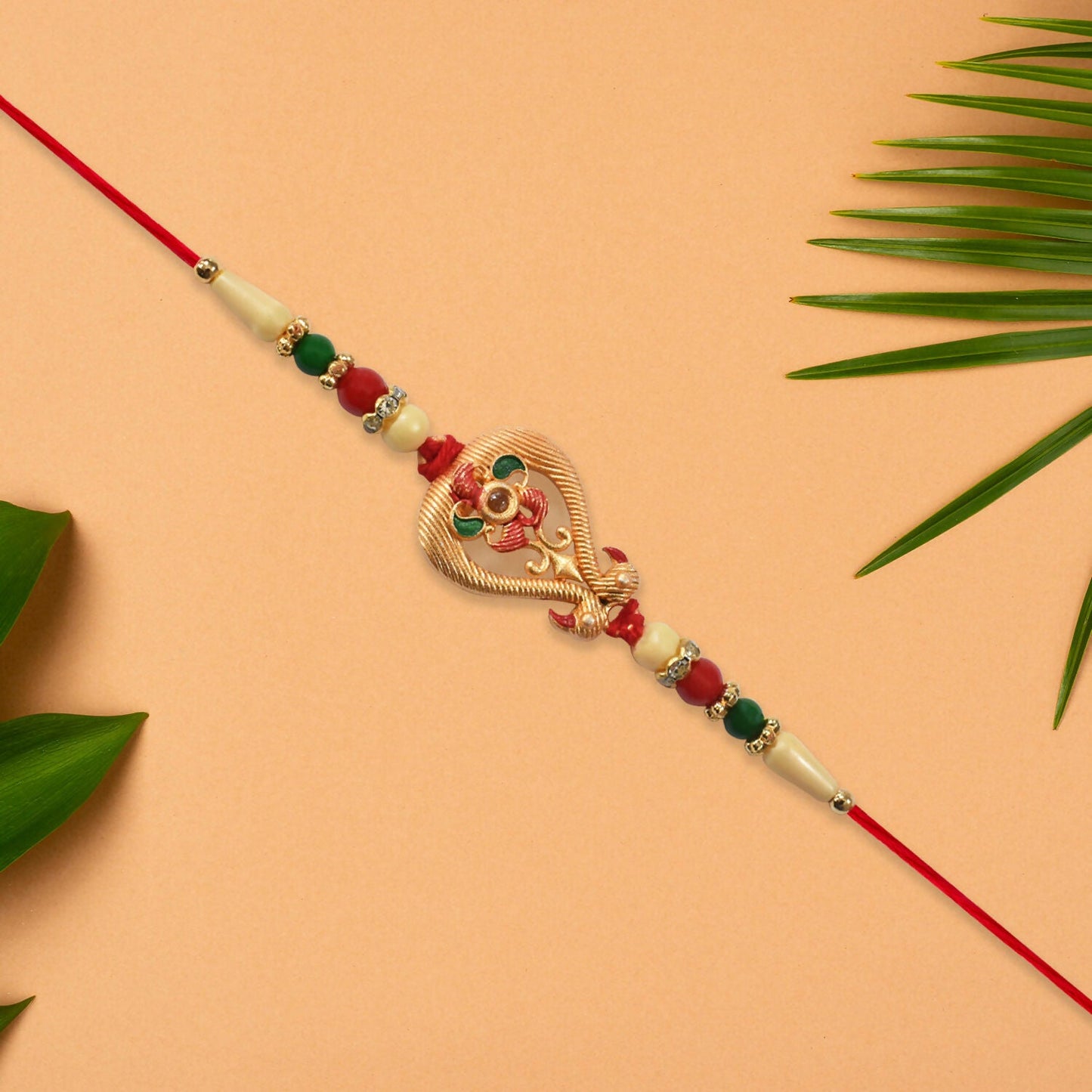 Close-up of central motif of designer Rakhi for brother highlighting fine craftsmanship.