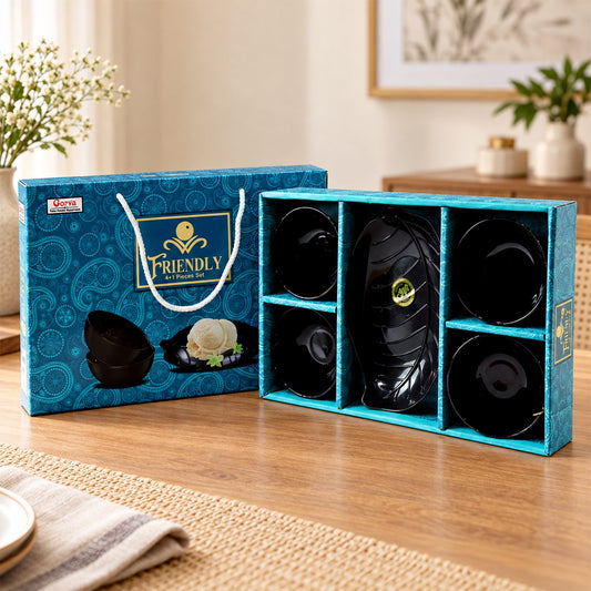 A black leaf-shaped platter and four small black bowls are displayed in a blue patterned gift box.