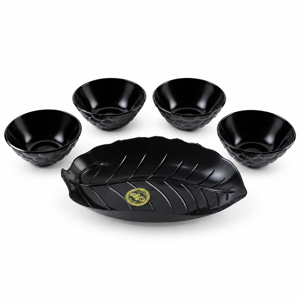 A black leaf-shaped platter and four small black bowls with textured exteriors are arranged on a white background.