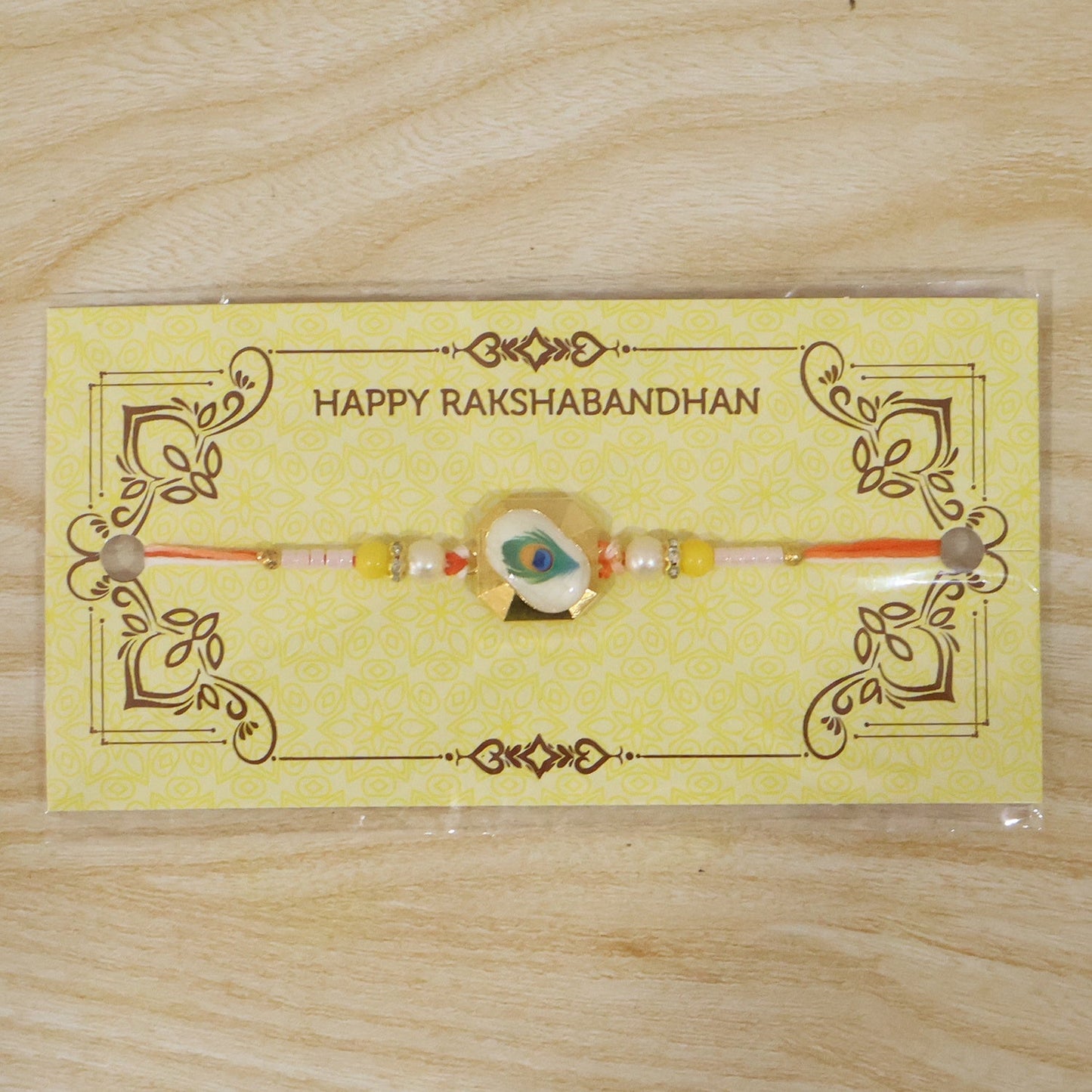 Peacock feather Rakhi tied on wrist for celebration