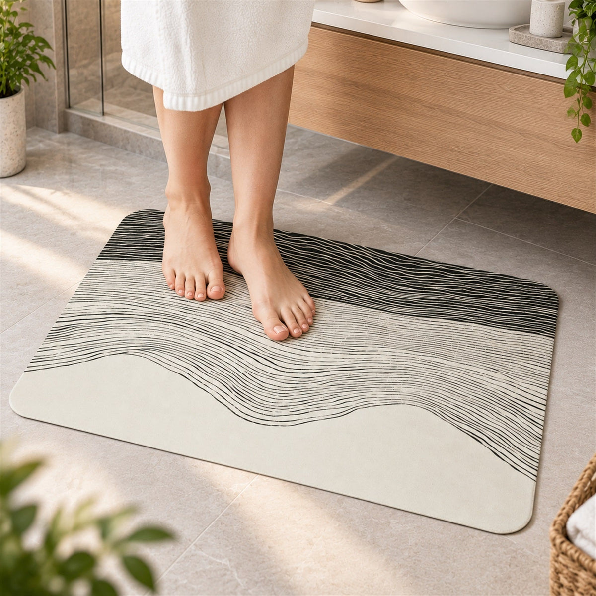A person stands on a rectangular mat with a black and white wavy design in a modern bathroom setting.