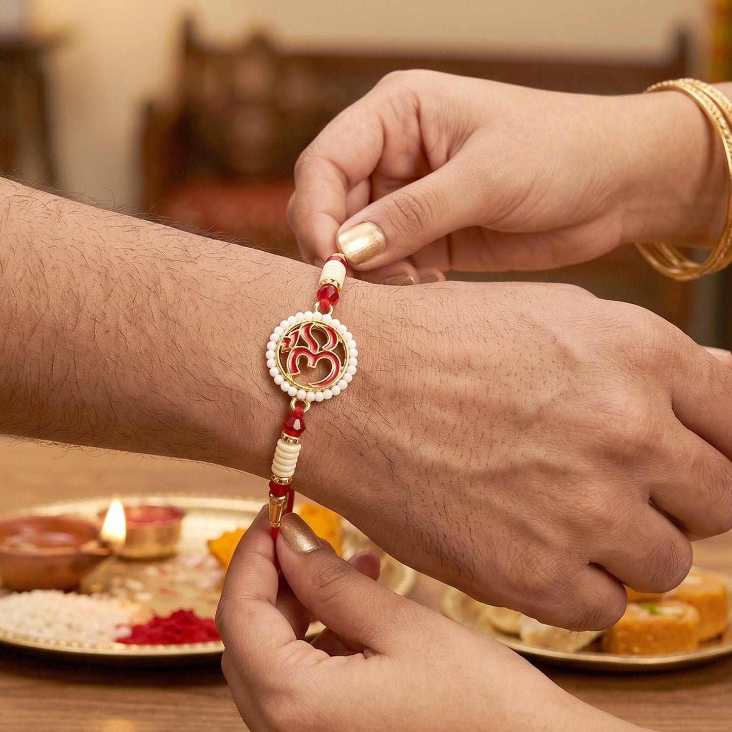 Close-up of OM symbol with decorative beads on Rakhi