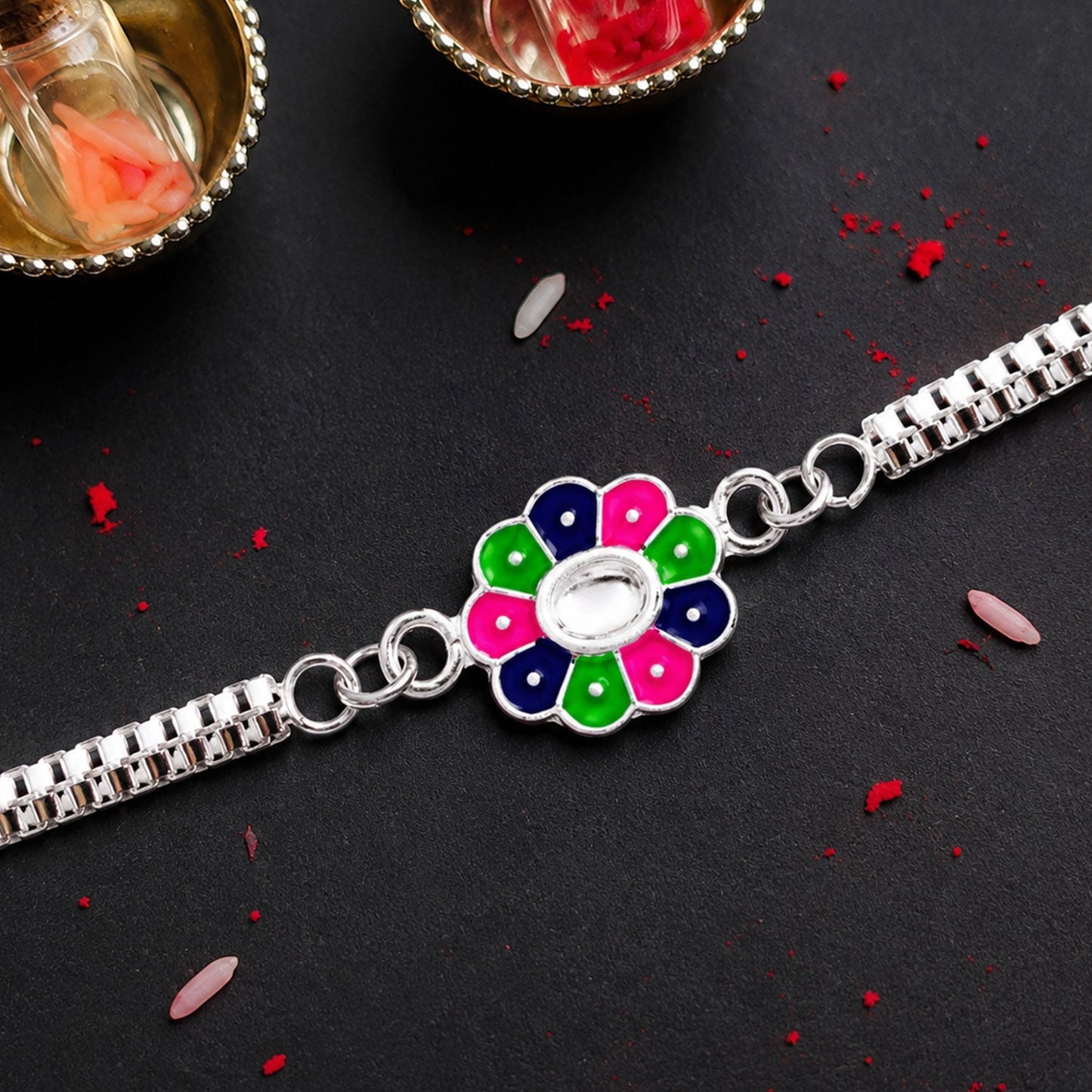Side view showcasing the comfortable chain bracelet style of the enamel work Rakhi.