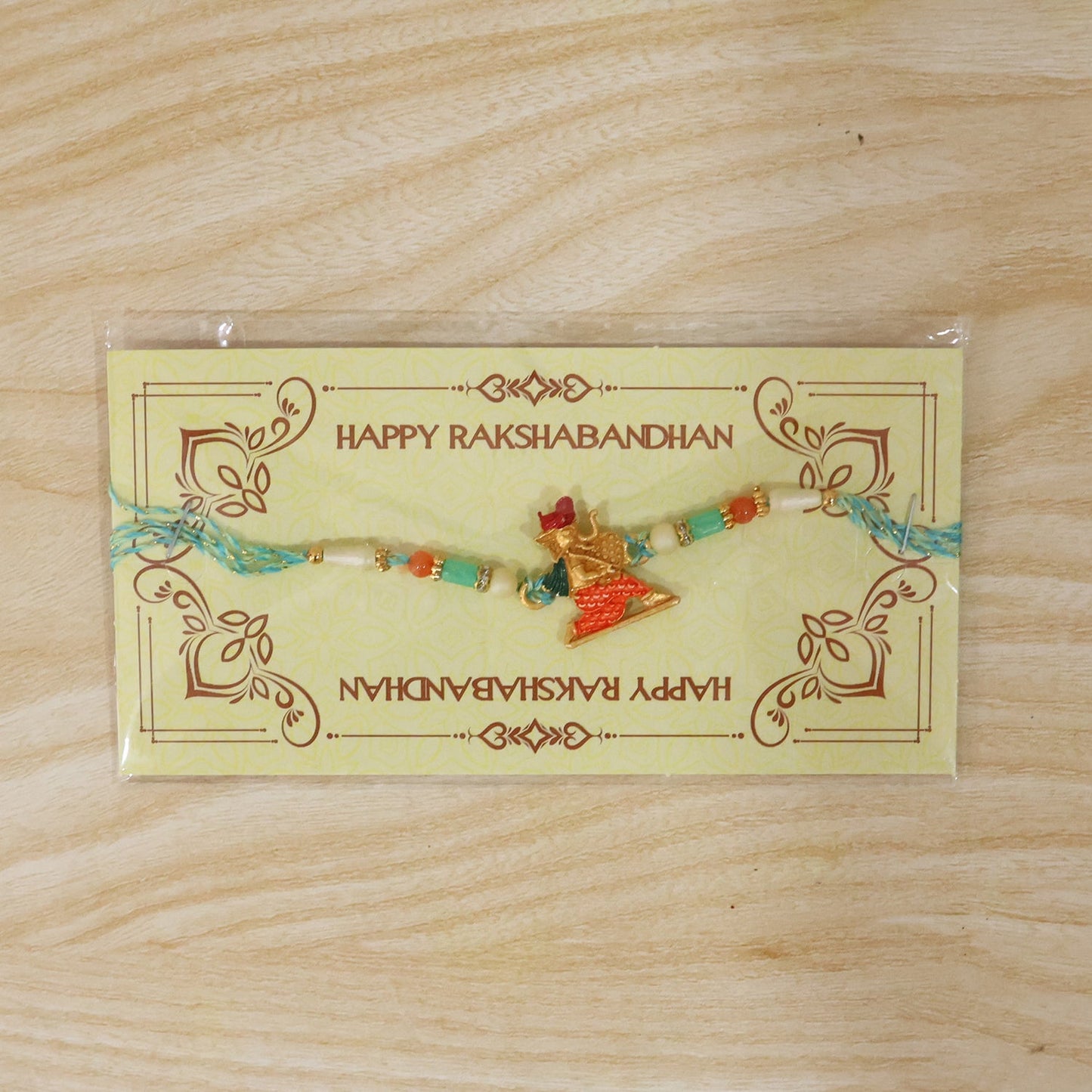 Decorative Ganesh rakhi with vibrant thread and bead details