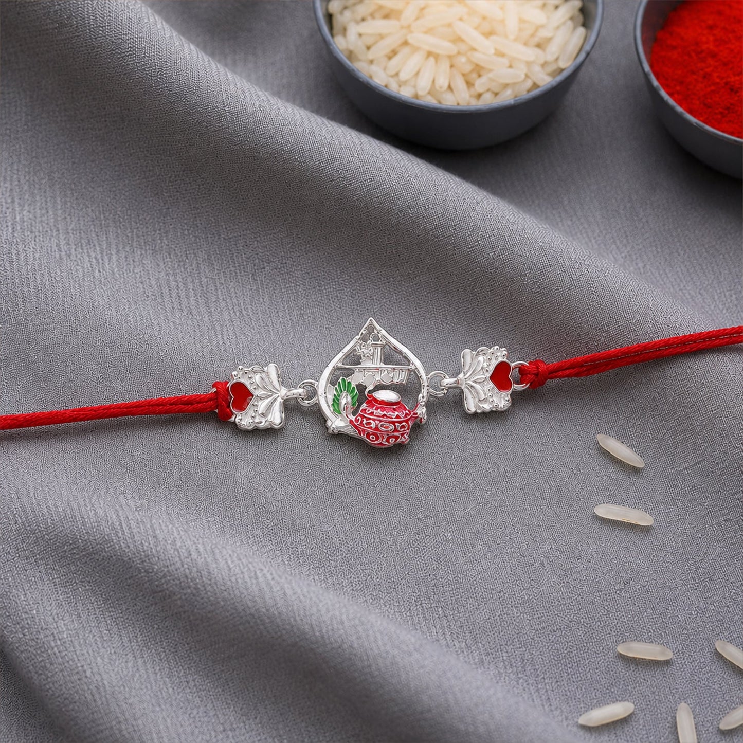 Close-up of Silver Crown Rakhi with pink stone and decorative beads