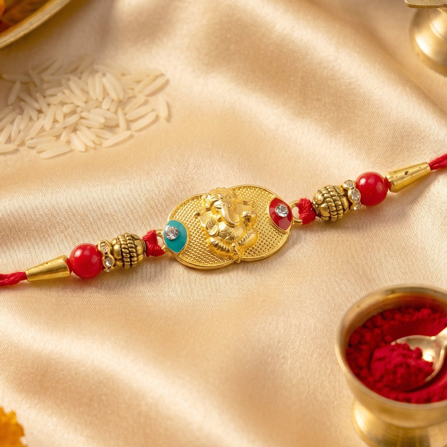 Close-up of Golden Ganesh Rakhi showcasing detailed beads and centerpiece