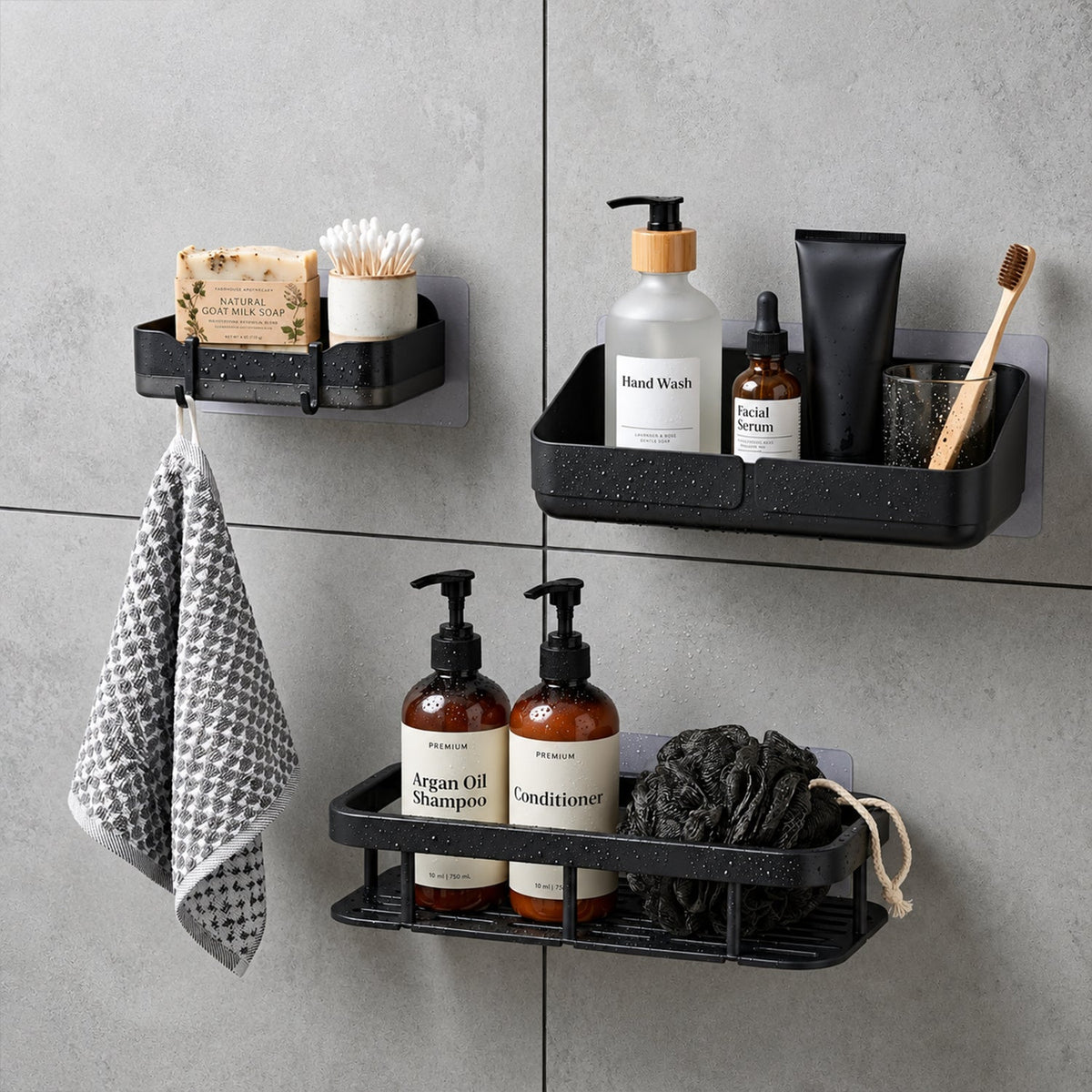 A black plastic shower caddy, soap dish, and rectangular shelf are mounted on a gray tiled wall, filled with toiletries.
