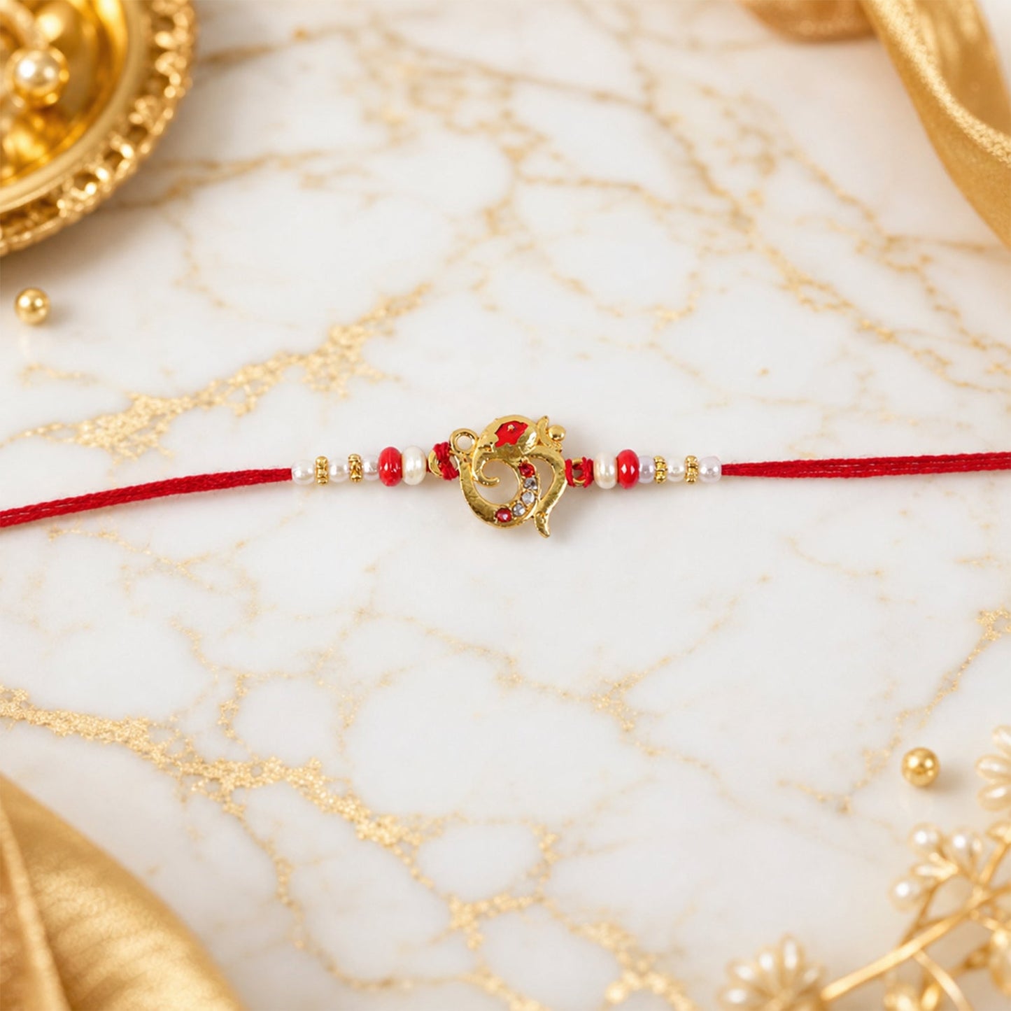 Elegant Rakhi with red beads and pearl accents on a festive thread