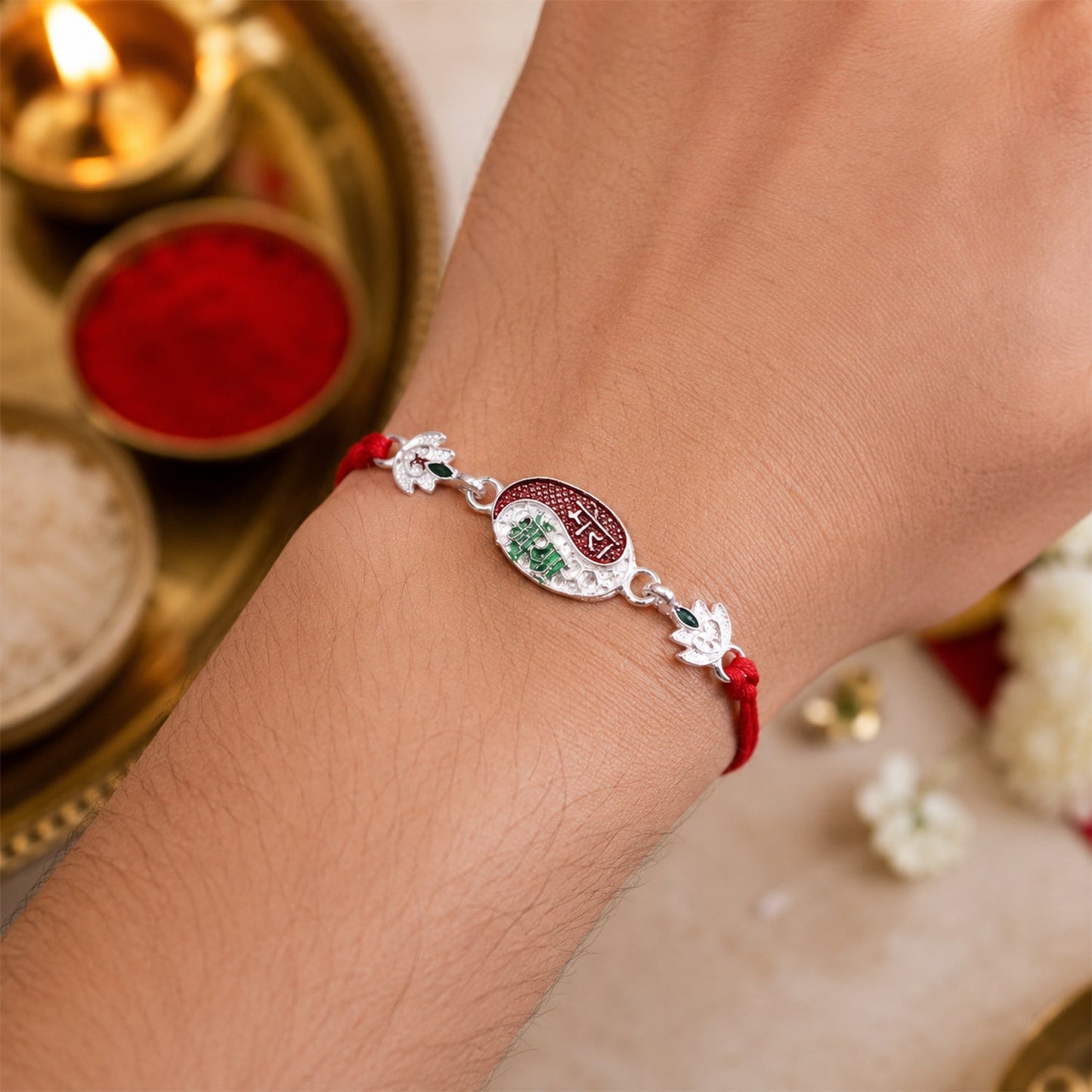Top-down view of the elegant Designer Rakhi with silver side charms.