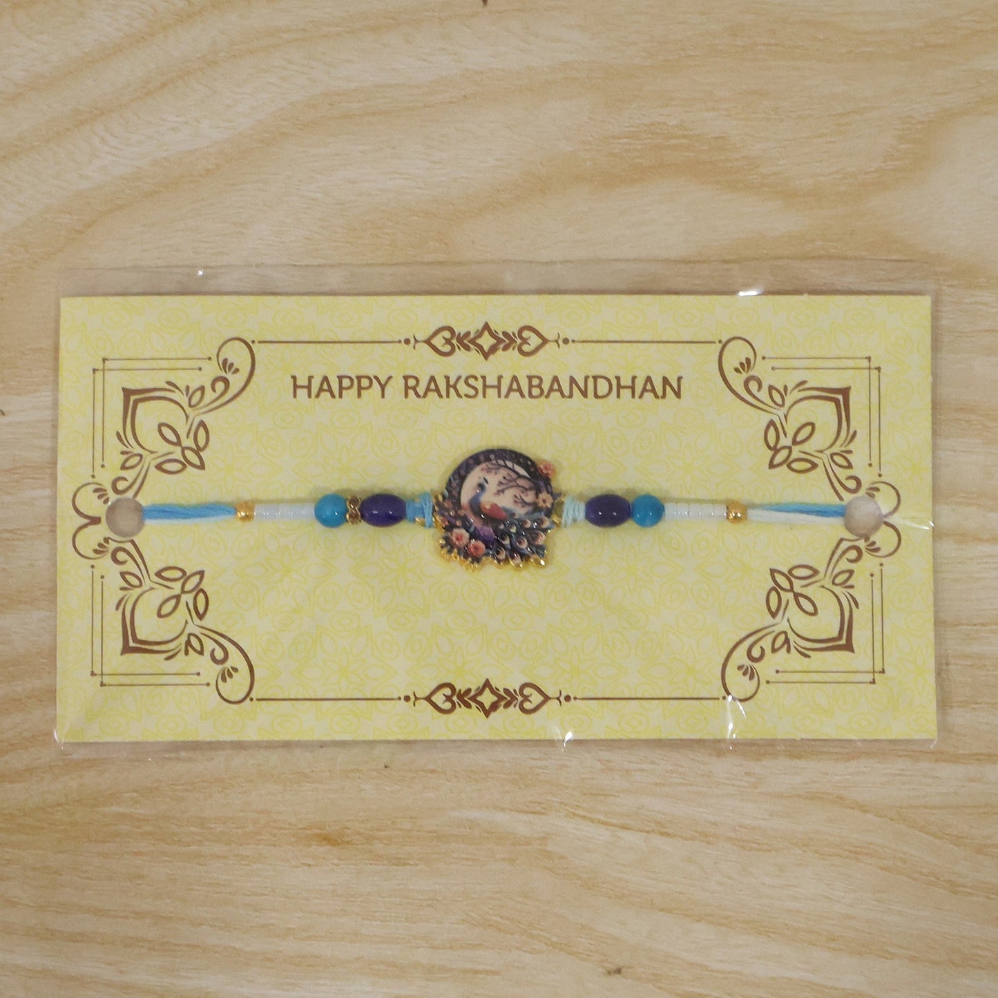 Soft-thread peacock Rakhi with beads and artistic detailing