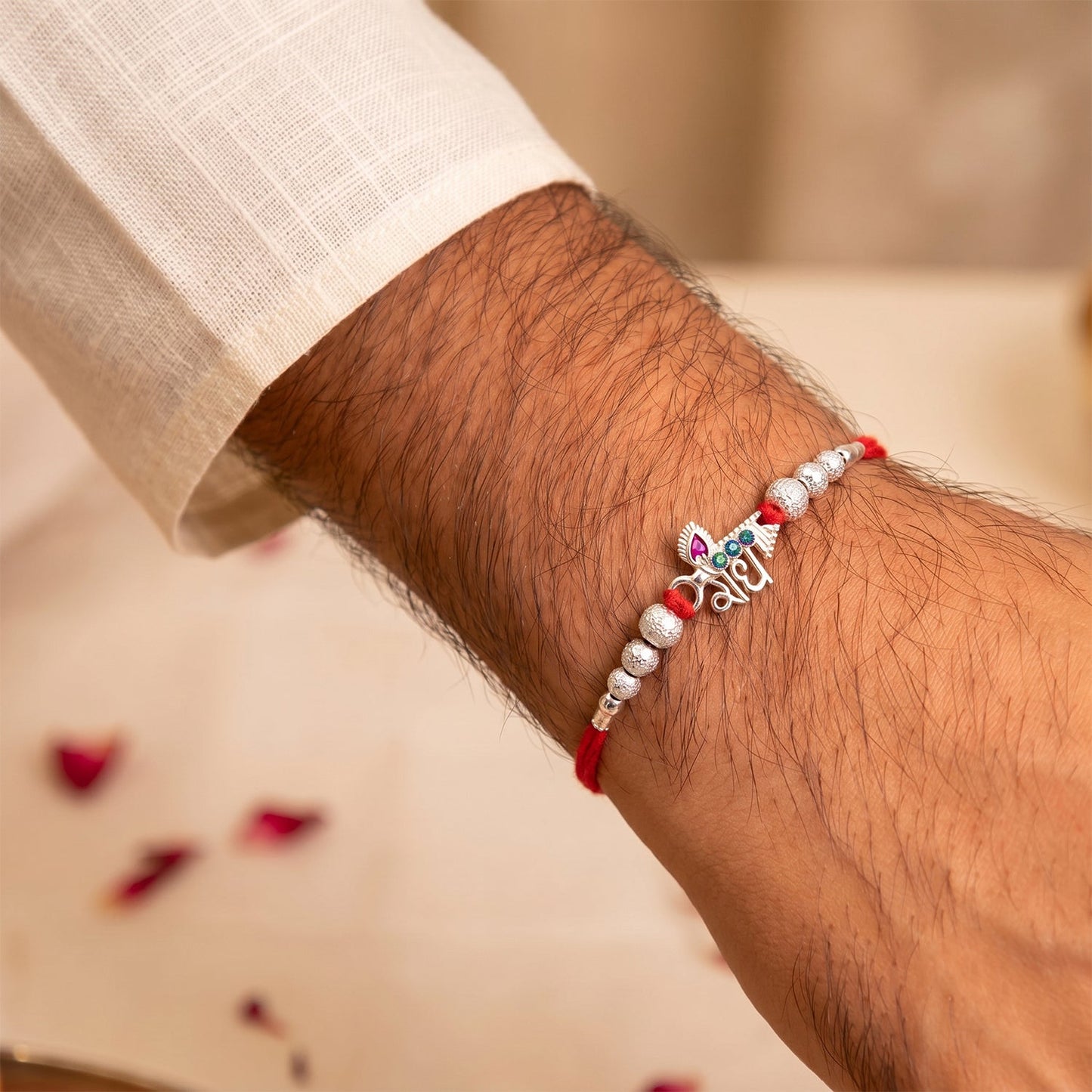 Radhe Silver Rakhi displayed against a festive background.
