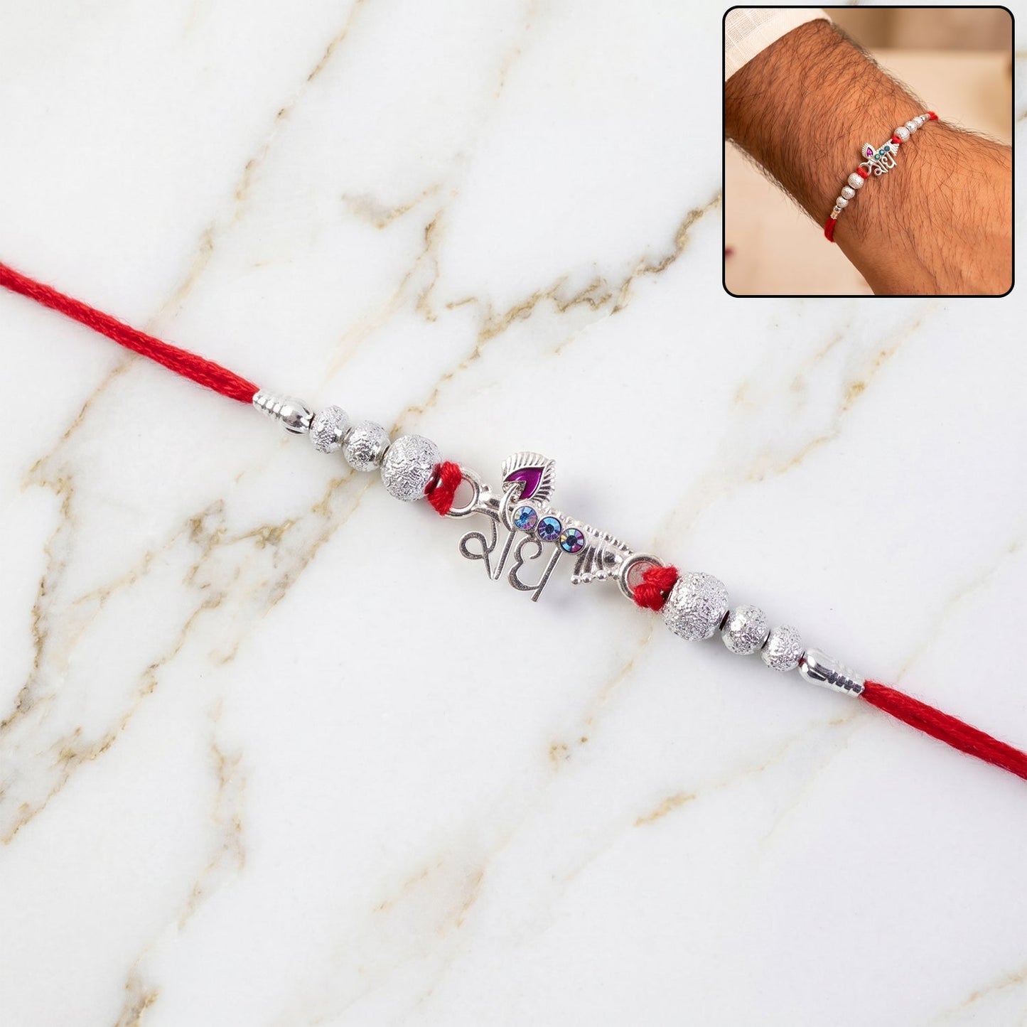 Elegant Radhe Silver Rakhi with decorative beads on a vibrant red thread.
