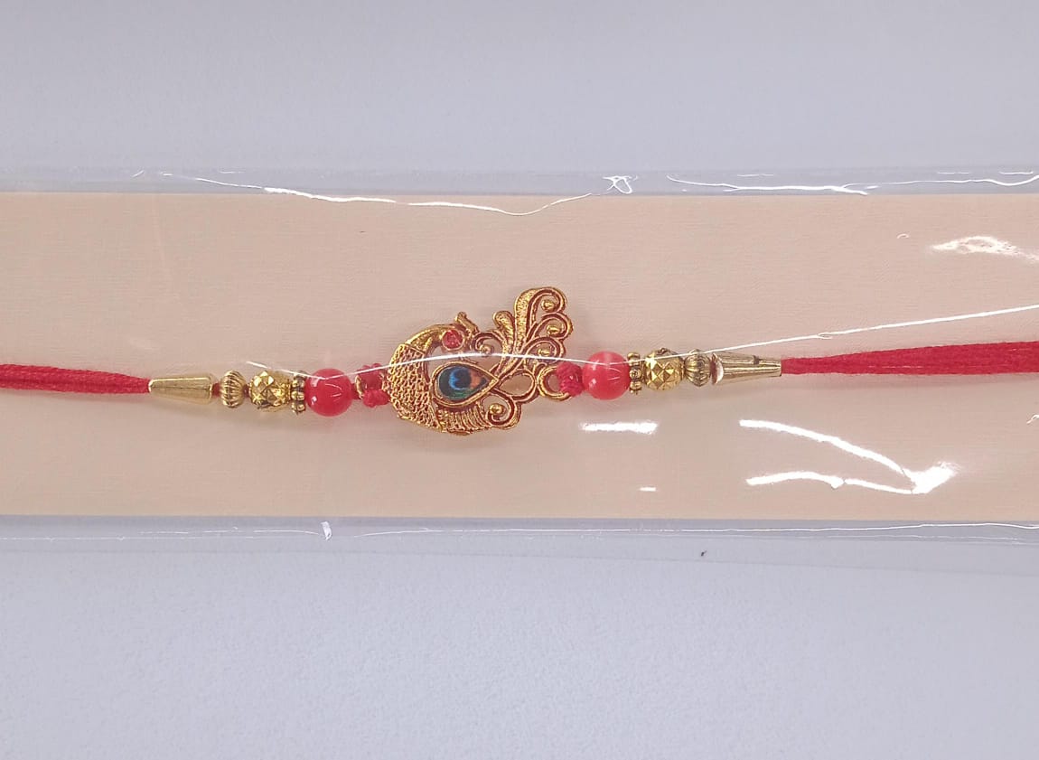 Peacock Rakhi with golden thread, ready to be tied on brother's wrist