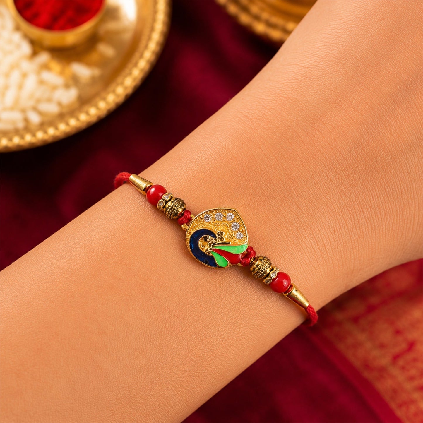 Elegant peacock feather rakhi with decorative elements for festival