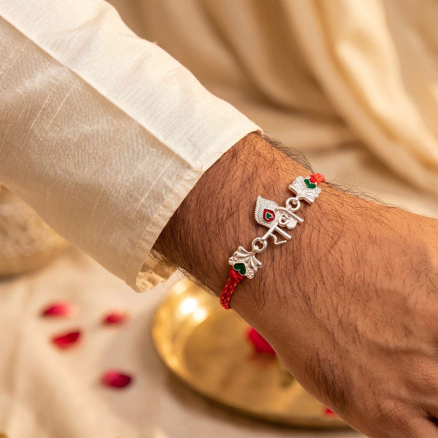 Decorative beads on Silver Radhe Morpich Rakhi with red thread