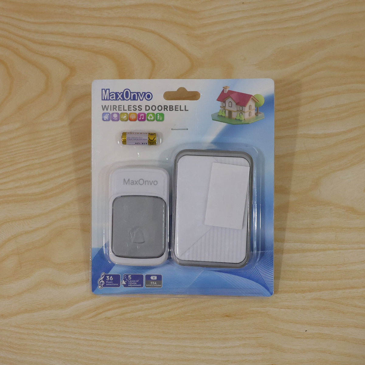 A wireless doorbell set, including a push button, receiver, and batteries, packaged in clear plastic on a light wooden