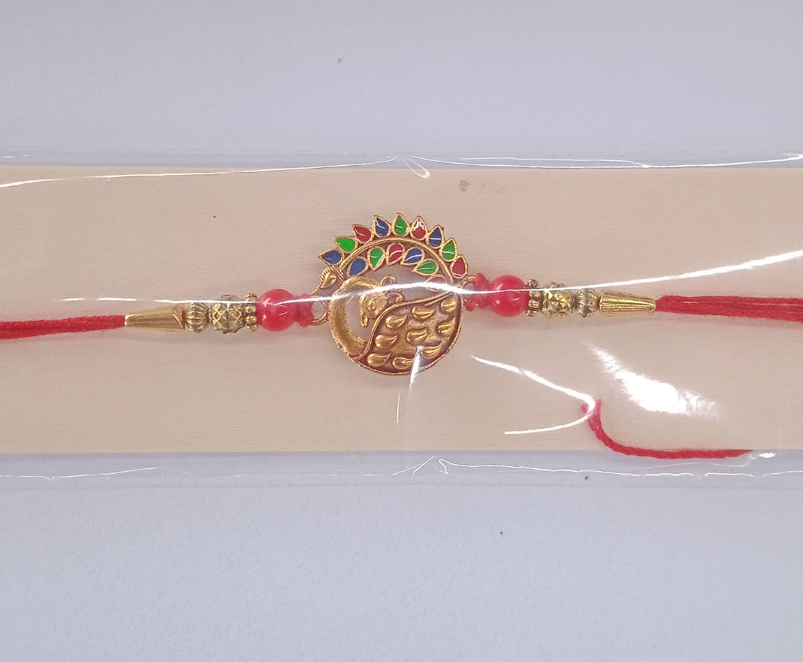 Golden peacock rakhi displayed as a special Rakshabandhan gift