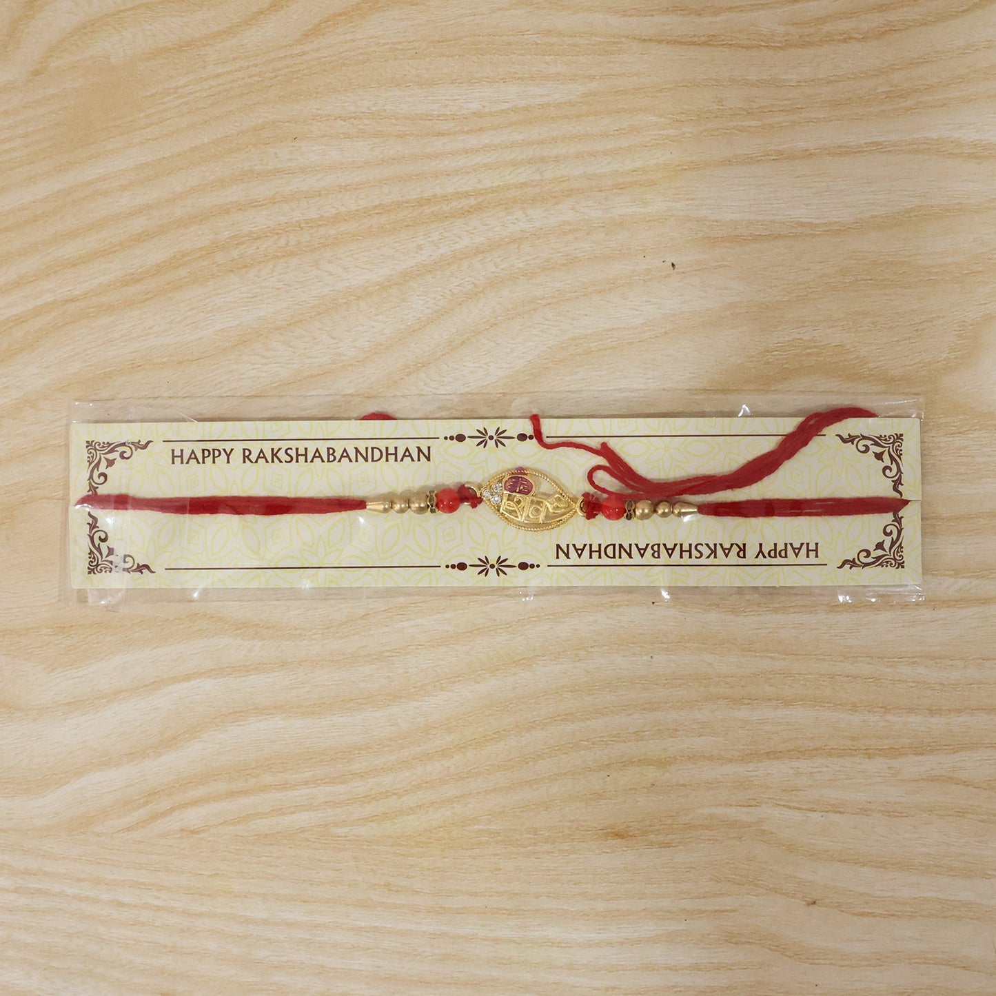 Neatly finished Gold Leaf Rakhi with beads and pearls