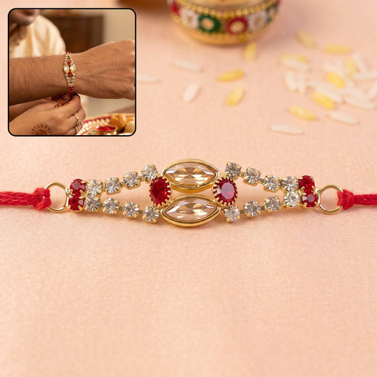 Elegant Oval Kundan Rakhi Bracelet with red and blue stones, front view.