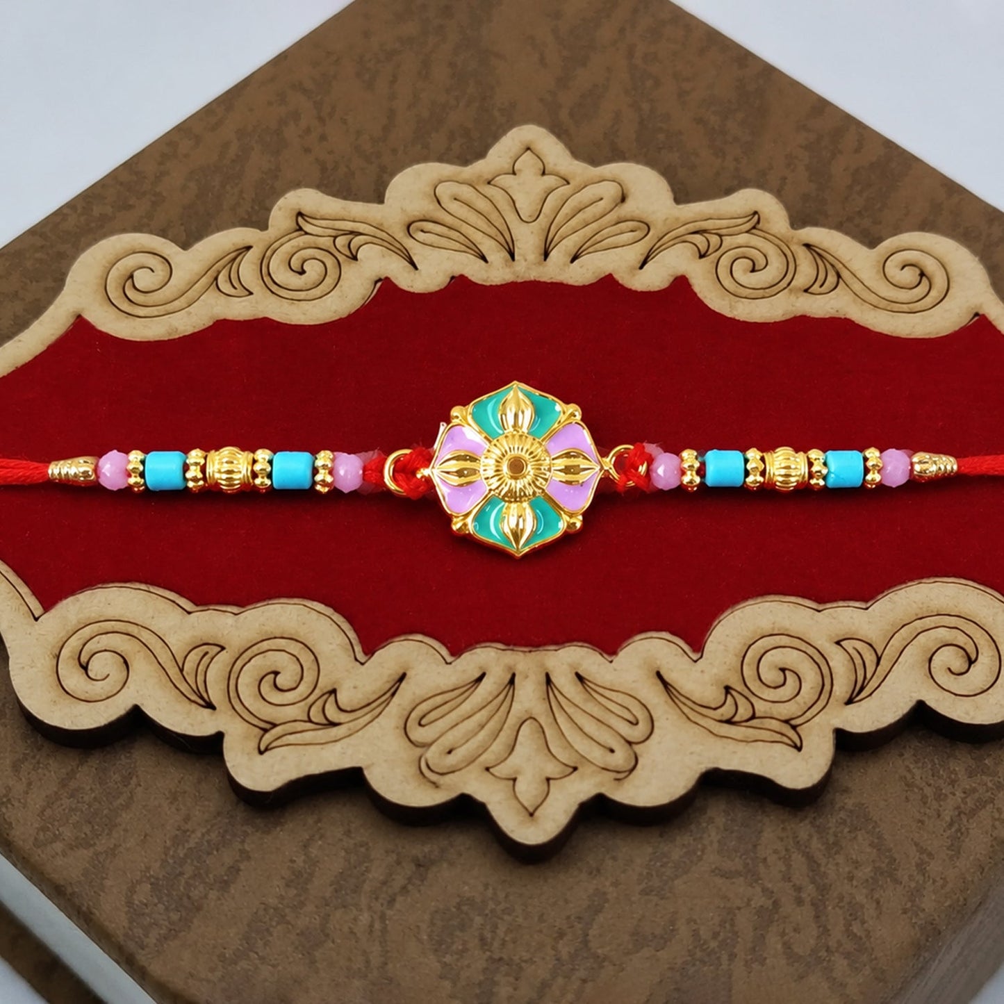 Flower motif rakhi with colorful beads and vibrant design