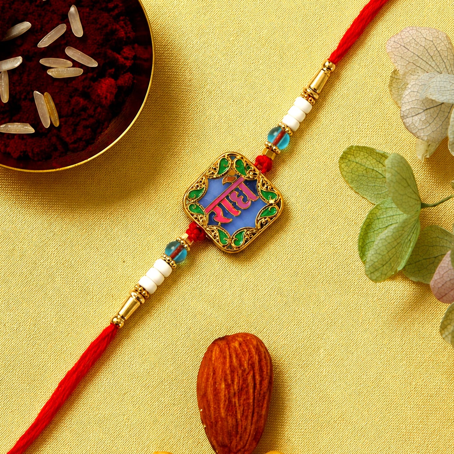 Rakhi with Radhe engraved centerpiece and colorful beads for Raksha Bandhan