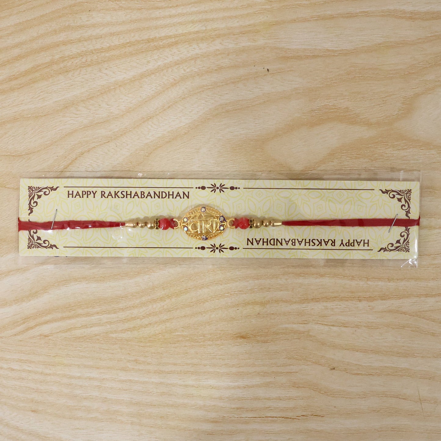 Golden Veera Rakhi showcasing decorative elements and thread design