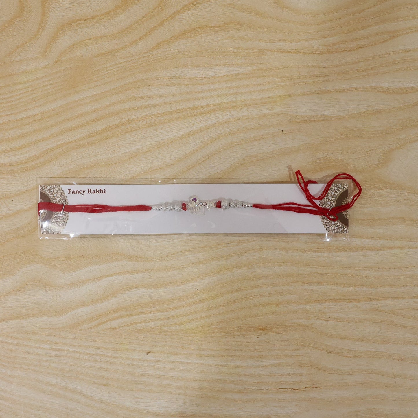 Festive presentation of Radhe Silver Rakhi for celebrations.