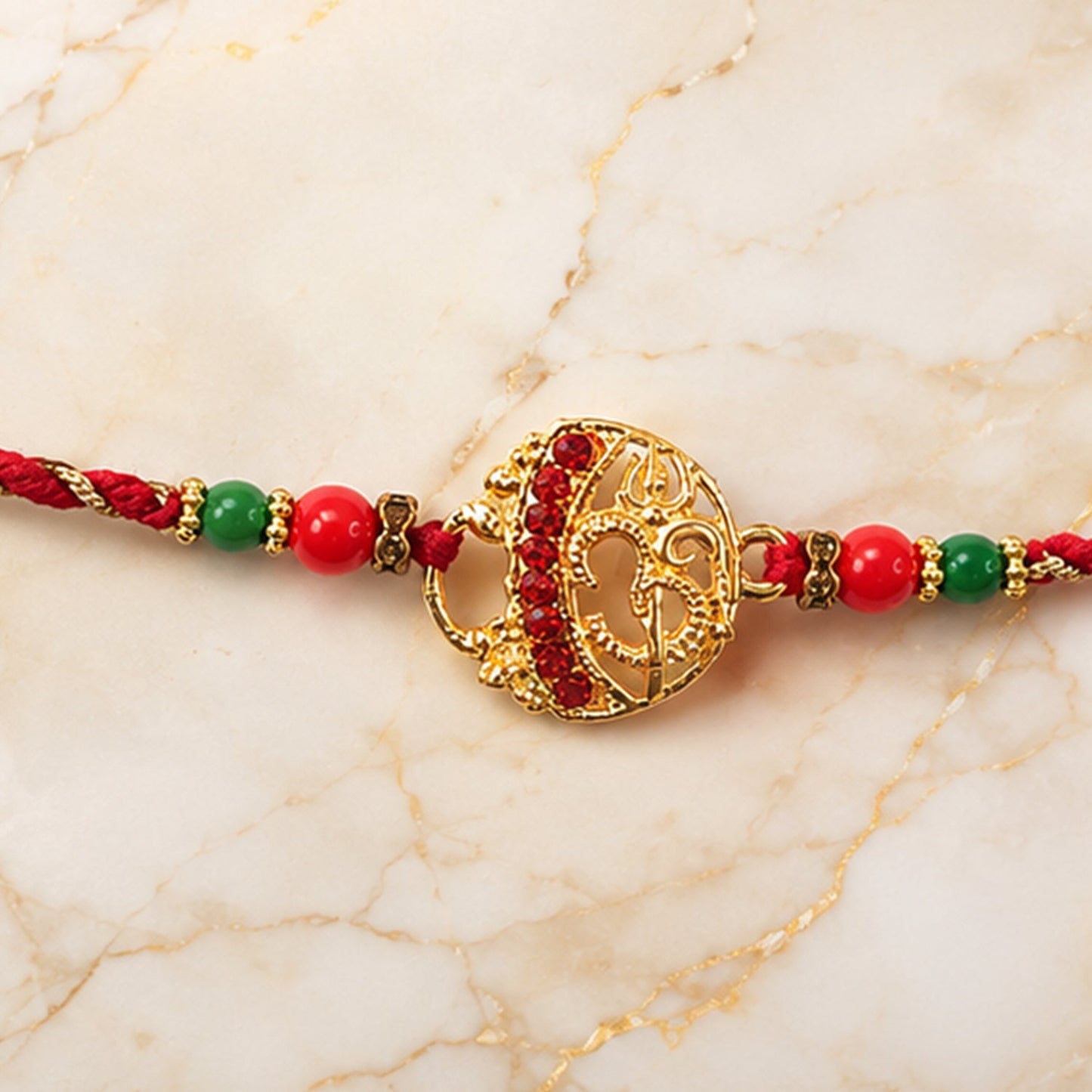 Decorative beaded Rakhi with twisted thread design, perfect for Raksha Bandhan celebrations