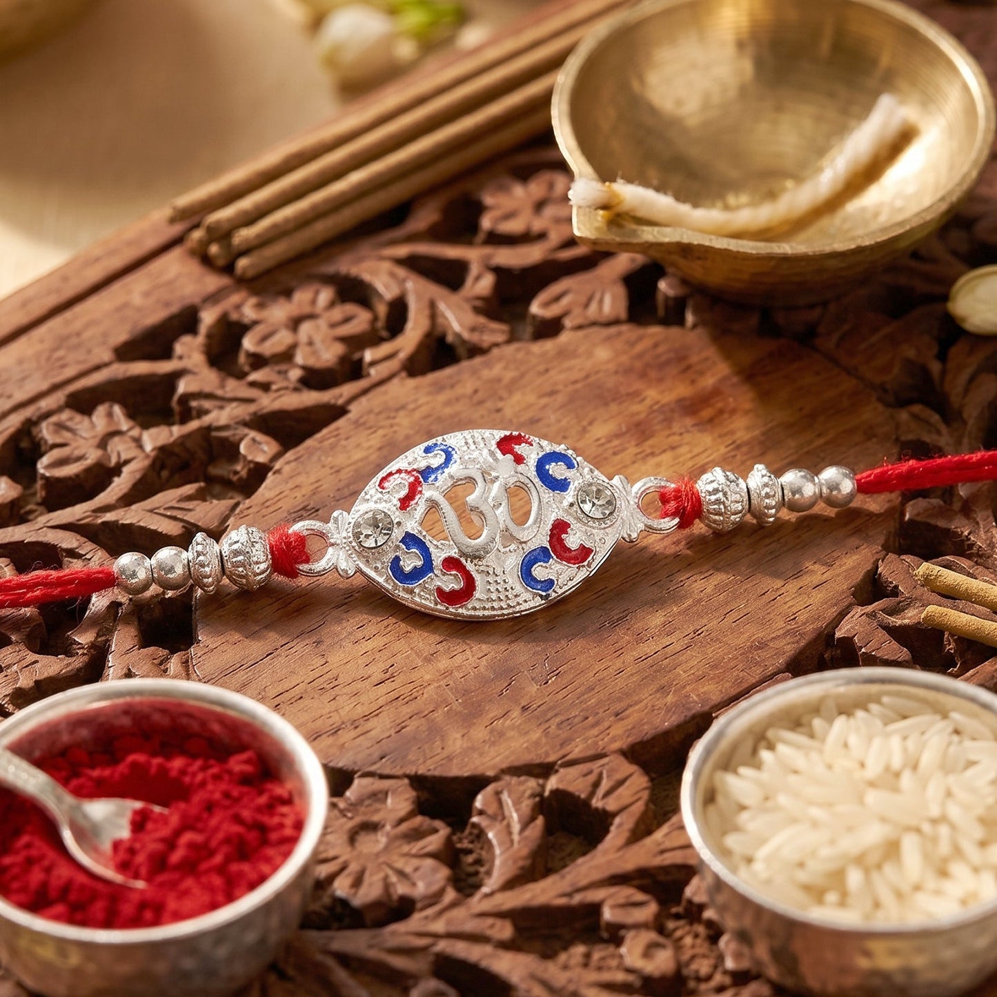 Close-up of decorative beads and colorful accents on silver Om rakhi